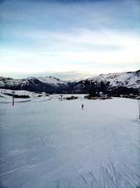 Scenic view of snow covered mountains against sky