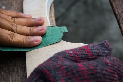 Close-up of hands working on table