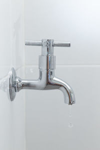 Close-up of faucet in bathroom