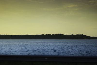 Scenic view of lake against sky at sunset