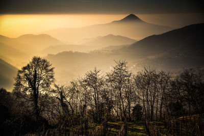 Scenic view of silhouette mountains against sky at sunset