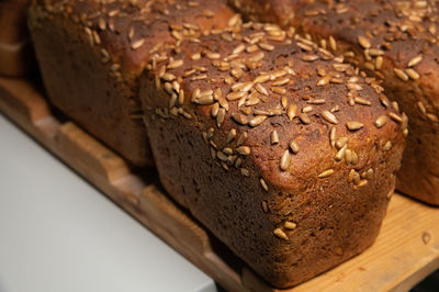 Fresh brown loaves of rye bread in the form of bricks with sunflower seeds on a crust. 