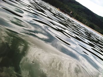 Close-up of water flowing against sky