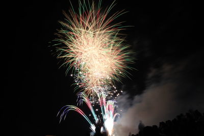 Low angle view of firework display at night