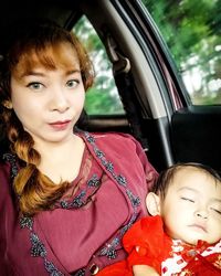 Portrait of cute girl sitting in car