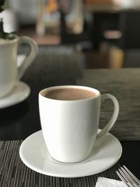 Close-up of coffee cup on table