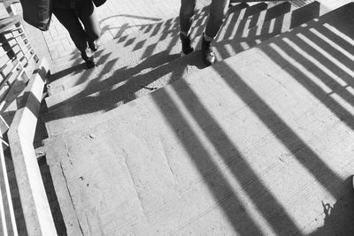 Low section of people walking on zebra crossing