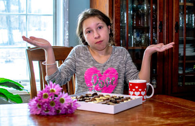 Portrait of woman sitting on table