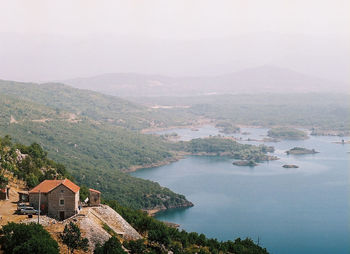 Scenic view of buildings and mountains against sky