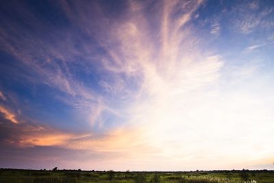 Scenic view of field against sky during sunset