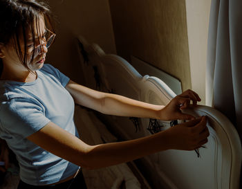 Side view of woman using mobile phone