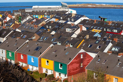 High angle view of houses by sea in town