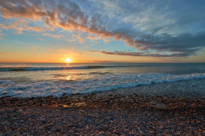 Scenic view of sea against sky during sunset