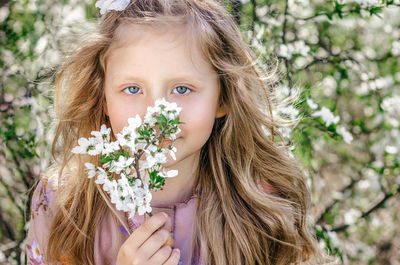 Spring, portrait on a background of blossoming cherry