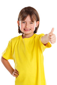 Portrait of smiling girl standing against white background