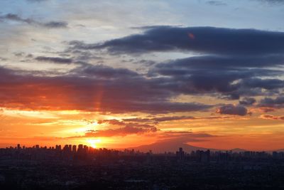 Silhouette buildings against sky during sunset