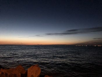 Scenic view of sea against sky at sunset