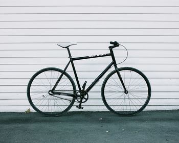 Close-up of bicycle against wall