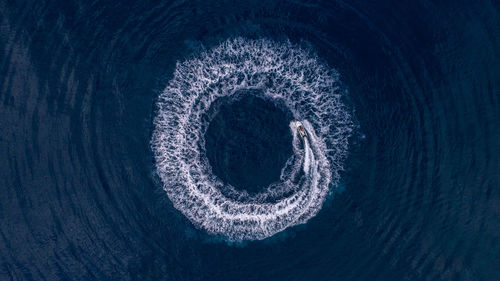 High angle view of blue sea seen through hole