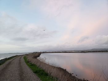 Road by sea against sky