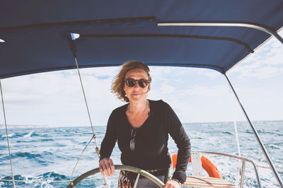 Woman with sunglasses on boat in sea