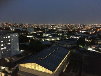 High angle view of illuminated buildings against sky at night