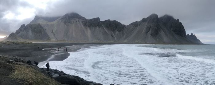Scenic view of mountains and sea against sky