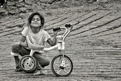 Portrait of girl sitting on land