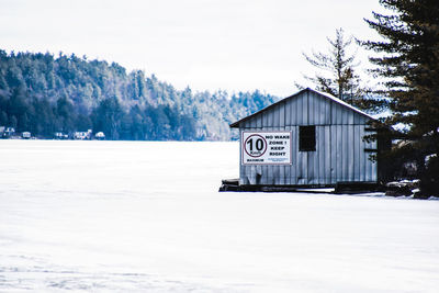 Boathouse on frozen lake