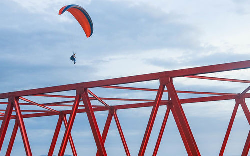 Low angle view of red flag against sky