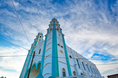 Low angle view of church against sky in city