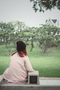 Rear view of woman sitting outdoors