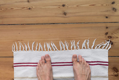 Low section of man standing on doormat