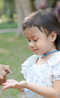 Child's hand was drenched with alcohol spray. prevent spread of bacteria and avoid coronavirus.