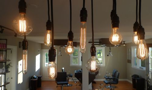 Illuminated light bulbs hanging from ceiling