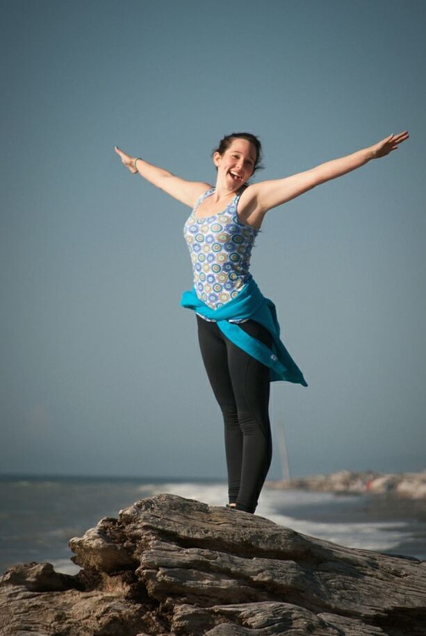 FULL LENGTH PORTRAIT OF YOUNG WOMAN STANDING ON SAND