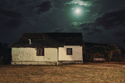 Abandoned house on field against sky
