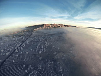 Aerial view of snowcapped mountain against sky