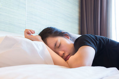 Young woman sleeping in bed