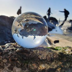 Close-up of crystal ball on rock