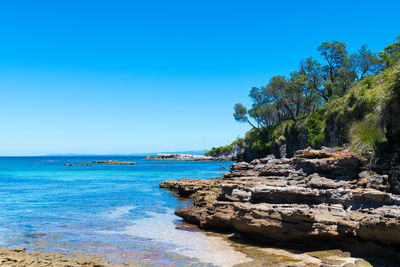 Scenic view of sea against clear blue sky