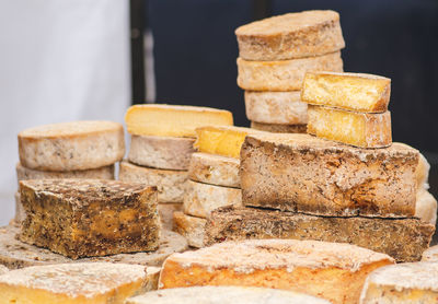 Variety of homemade bio natural seasoned cheese in a street food market ready to eat, close up