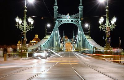 Illuminated liberty bridge against sky at night