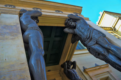 Low angle view of statue against historic building