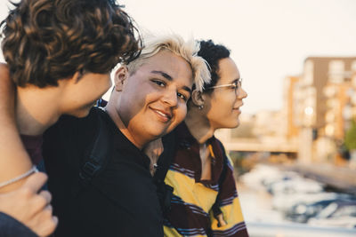 Portrait of smiling friends standing in city