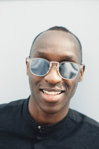 Portrait of serene young man with mirrored sunglasses