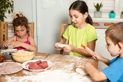 Kids preparing food while sitting at home