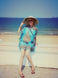 Portrait of woman standing on beach