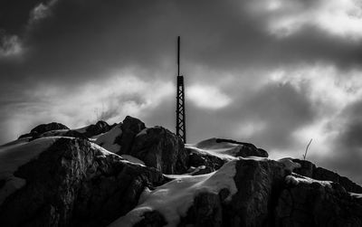Low angle view of mountain against sky during winter