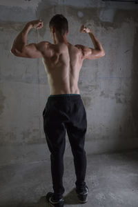 Rear view of shirtless man standing